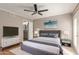 Comfortable bedroom with a ceiling fan, a mounted TV, and a luxurious platform bed at 835 N Granite Reef Rd # 29, Scottsdale, AZ 85257