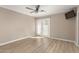 Empty bedroom featuring wood-look flooring, a ceiling fan, and sliding glass doors at 835 N Granite Reef Rd # 29, Scottsdale, AZ 85257