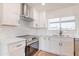 Close-up of a kitchen featuring white cabinets, stainless steel appliances, and a subway tile backsplash at 9028 N 48Th Dr, Glendale, AZ 85302