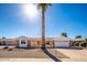 Charming single-story home with a well-manicured front yard, desert landscaping and a prominent palm tree at 9607 W Briarwood Cir, Sun City, AZ 85351