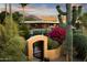 Lush backyard with a pool, patio, mature trees, and vibrant plants, creating a private and serene oasis at 9716 E Mariposa Grande Dr, Scottsdale, AZ 85255