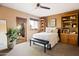 Bedroom featuring wood shelving, a ceiling fan, and glass doors leading to an outdoor patio at 9716 E Mariposa Grande Dr, Scottsdale, AZ 85255