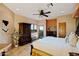 Bright main bedroom with ample sunlight, wood furniture, and balcony access at 9716 E Mariposa Grande Dr, Scottsdale, AZ 85255