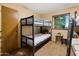 Bedroom featuring built-in bunk beds, a neutral color palette, and a window for natural light at 9716 E Mariposa Grande Dr, Scottsdale, AZ 85255