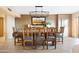 Elegant dining room featuring a large table with seating for eight and stylish lighting fixture at 9716 E Mariposa Grande Dr, Scottsdale, AZ 85255