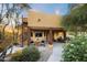 Charming home exterior with a spiral staircase, covered patio, and lush landscaping providing a welcoming curb appeal at 9716 E Mariposa Grande Dr, Scottsdale, AZ 85255