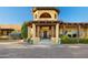 Stunning home entrance with a tower, arched doorway, stone steps, and lovely landscaping, creating a welcoming approach at 9716 E Mariposa Grande Dr, Scottsdale, AZ 85255