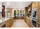 Bright kitchen with a large sink, custom cabinets, stainless steel appliances, and unique flooring at 9716 E Mariposa Grande Dr, Scottsdale, AZ 85255