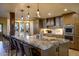 Gourmet kitchen features a huge center island, barstool seating, and custom pendant lighting at 9716 E Mariposa Grande Dr, Scottsdale, AZ 85255