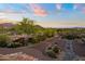 Beautifully landscaped driveway leading up to the property with mountains in the background at sunset at 9716 E Mariposa Grande Dr, Scottsdale, AZ 85255