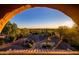 Desert landscape view with native plants framed through an arched opening, providing a unique perspective at 9716 E Mariposa Grande Dr, Scottsdale, AZ 85255