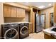 Laundry area features stone countertops, cabinetry, laundry sink, stainless steel refrigerator, and appliances at 9716 E Mariposa Grande Dr, Scottsdale, AZ 85255