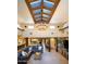 Open living area with a statement chandelier, stone floors, wood beams, and seamless flow at 9716 E Mariposa Grande Dr, Scottsdale, AZ 85255
