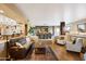 Spacious living room with hardwood floors, comfortable seating, and an adjacent dining area, perfect for gatherings at 9716 E Mariposa Grande Dr, Scottsdale, AZ 85255