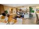 Open living area with diverse flooring, comfortable seating, a fireplace, and seamless flow into other spaces at 9716 E Mariposa Grande Dr, Scottsdale, AZ 85255