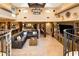 Expansive living area with a large sectional, stone floors, wood beams, and abundant natural light at 9716 E Mariposa Grande Dr, Scottsdale, AZ 85255