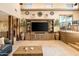 Spacious living room boasts a custom entertainment center, unique architecture, and stone flooring at 9716 E Mariposa Grande Dr, Scottsdale, AZ 85255