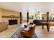 Open-concept living area featuring a stone fireplace, comfortable seating, and pool table for entertainment at 9716 E Mariposa Grande Dr, Scottsdale, AZ 85255