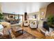 Bright living room with a fireplace, comfortable seating, and an adjacent dining area with ample natural light at 9716 E Mariposa Grande Dr, Scottsdale, AZ 85255