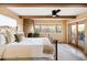 Bright main bedroom featuring a fireplace, ceiling fan, and access to a private outdoor patio at 9716 E Mariposa Grande Dr, Scottsdale, AZ 85255
