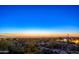 Picturesque desert landscape view with city lights at night, framed by cacti and a colorful sunset sky at 9716 E Mariposa Grande Dr, Scottsdale, AZ 85255