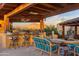 Entertain outdoors at the covered patio kitchen with built in barbeque, bar seating and mountain views at 9716 E Mariposa Grande Dr, Scottsdale, AZ 85255