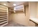 Spacious walk-in closet with custom shelving and ample storage space for clothes, shoes and accessories at 9716 E Mariposa Grande Dr, Scottsdale, AZ 85255