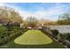 Well-manicured backyard with a putting green, surrounded by landscaping and privacy walls at 10244 E Hualapai Dr, Scottsdale, AZ 85255