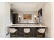 Stylish bar area featuring dark wood cabinetry, light countertops, and comfortable seating at 10244 E Hualapai Dr, Scottsdale, AZ 85255