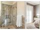 Beautiful bathroom with glass enclosed shower, decorative tile, neutral color scheme and linen closet at 10244 E Hualapai Dr, Scottsdale, AZ 85255