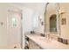 Bright bathroom featuring tiled walk-in shower, vanity, and decorative mirror at 10244 E Hualapai Dr, Scottsdale, AZ 85255