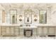 Elegant bathroom features marble walls, dual sinks, vanity, stylish sconces, and ample storage space at 10244 E Hualapai Dr, Scottsdale, AZ 85255