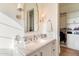 Bathroom with marble vanity, makeup mirror, modern fixtures, and a walk-in closet at 10244 E Hualapai Dr, Scottsdale, AZ 85255