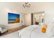 Bright bedroom featuring luxury finishes, chandelier, and view into the living room at 10244 E Hualapai Dr, Scottsdale, AZ 85255