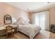 Bright bedroom with pink wallpaper, white bedding, white curtains and a wood floor at 10244 E Hualapai Dr, Scottsdale, AZ 85255