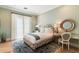 Bright bedroom with floral accents, desk, and a large window providing natural light at 10244 E Hualapai Dr, Scottsdale, AZ 85255