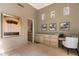 Light-filled bedroom with a desk, artwork, and access to the en-suite bathroom at 10244 E Hualapai Dr, Scottsdale, AZ 85255