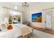 Bright bedroom featuring pool view, chandelier, and neutral decor at 10244 E Hualapai Dr, Scottsdale, AZ 85255