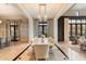 Bright dining room featuring a long table with seating for ten, elegant lighting, and an open floor plan at 10244 E Hualapai Dr, Scottsdale, AZ 85255