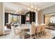 Open-concept dining room with a large table, stylish chandelier, and a seamless flow into the living area at 10244 E Hualapai Dr, Scottsdale, AZ 85255