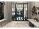 Foyer with black and white checkered floors, chandelier, and grand doors leading to the front entrance at 10244 E Hualapai Dr, Scottsdale, AZ 85255