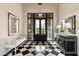 Foyer with black and white checkered floors, chandelier, console table and artwork at 10244 E Hualapai Dr, Scottsdale, AZ 85255