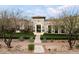 Charming home displaying lush landscaping, a well-manicured lawn, and an inviting walkway to the elegant front entrance at 10244 E Hualapai Dr, Scottsdale, AZ 85255