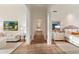 Bright hallway with hardwood floors leads to bedroom and living area with modern decor at 10244 E Hualapai Dr, Scottsdale, AZ 85255