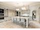 Elegant kitchen with a marble island, modern appliances, custom cabinetry, and stylish pendant lighting at 10244 E Hualapai Dr, Scottsdale, AZ 85255