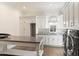 Spacious laundry room features white cabinetry, mosaic backsplash, large island, and stainless steel washer and dryer at 10244 E Hualapai Dr, Scottsdale, AZ 85255