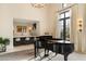 A view of the living room with a bar and piano featuring great natural light at 10244 E Hualapai Dr, Scottsdale, AZ 85255