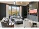 Comfortable living room featuring a large window with mountain views and a built-in entertainment center at 10244 E Hualapai Dr, Scottsdale, AZ 85255