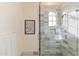 Shower stall enclosed with glass, featuring marble tiling and gold fixtures at 10244 E Hualapai Dr, Scottsdale, AZ 85255