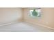 Neutral bedroom with wall to wall carpet and large window at 10816 W Hatcher Rd, Sun City, AZ 85351